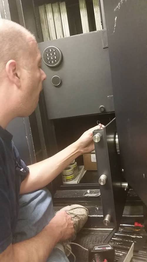 image of one of Sprouse's technicians repairing a safe.